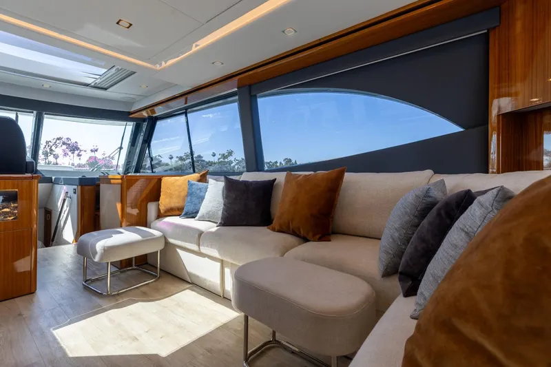 Slide: The Image of Luxurious interior of 2022 Riviera 645 SUV yacht with plush seating and panoramic windows. - 14