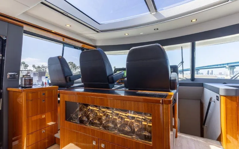 Slide: The Image of Luxurious interior of 2022 Riviera 645 SUV yacht with leather seats and panoramic windows. - 16