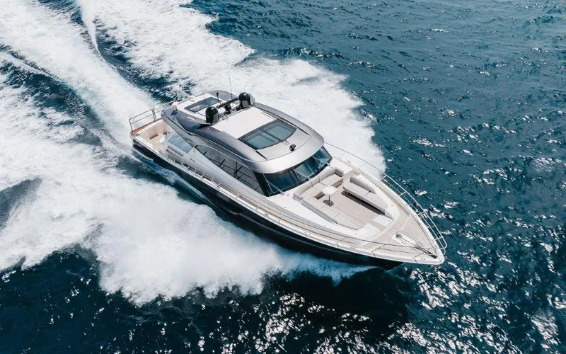 Slide: The Image of 2022 Riviera 645 SUV yacht cruising on open ocean waters. - 2