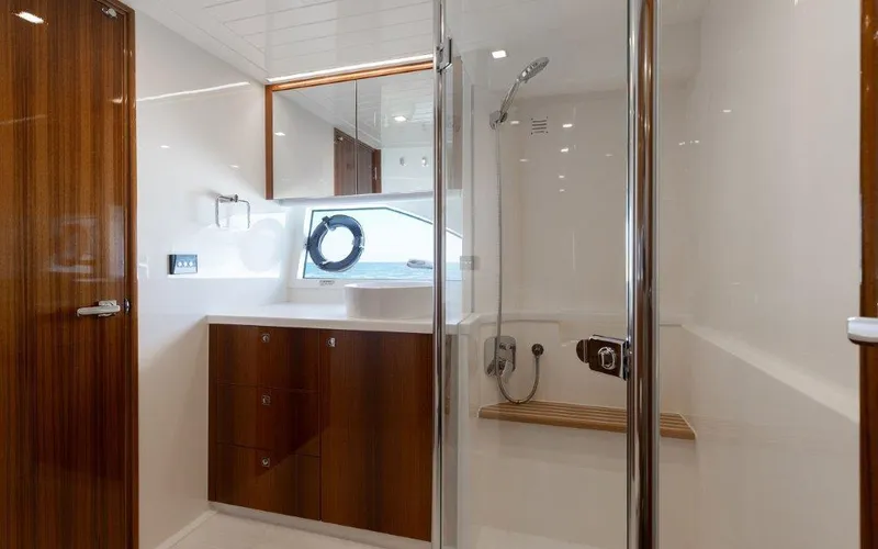 Slide: The Image of Luxurious bathroom interior of 2022 Riviera 645 SUV yacht with wooden cabinetry and modern shower. - 23