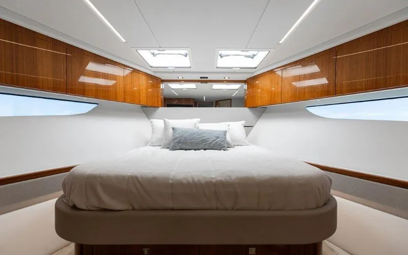 Slide: The Image of Luxurious bedroom interior of 2022 Riviera 645 SUV yacht with elegant wood finishes. - 24