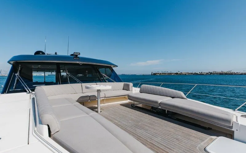 Slide: The Image of 2022 Riviera 645 SUV yacht with spacious deck and seating, cruising on a sunny day. - 28