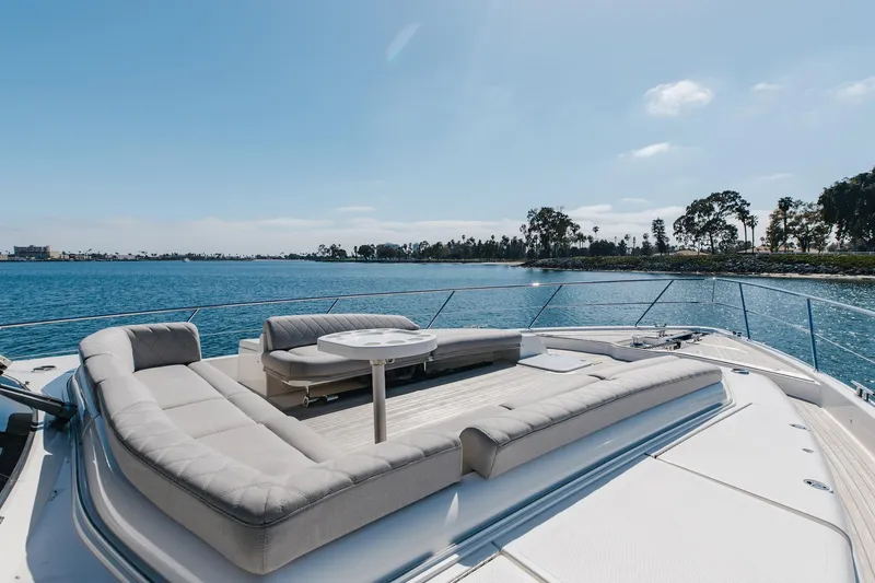 Slide: The Image of 2022 Riviera 645 SUV yacht with luxurious deck seating, ocean view, and clear blue sky. - 29