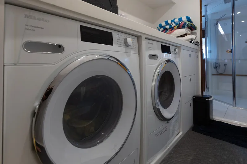 Slide: The Image of Laundry room with modern washing machines inside a 2022 Riviera 645 SUV. - 31