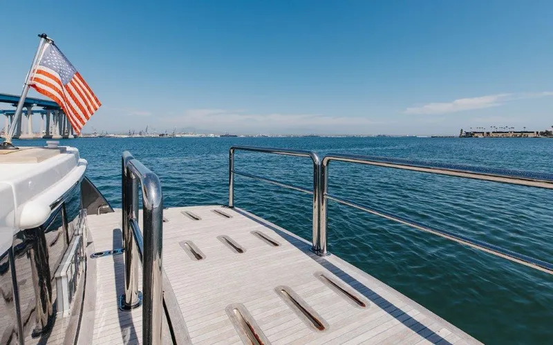 Slide: The Image of 2022 Riviera 645 SUV yacht deck with ocean view and American flag. - 4