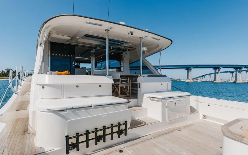 Slide: The Image of 2022 Riviera 645 SUV yacht with spacious deck, modern design, and scenic bridge view. - 5