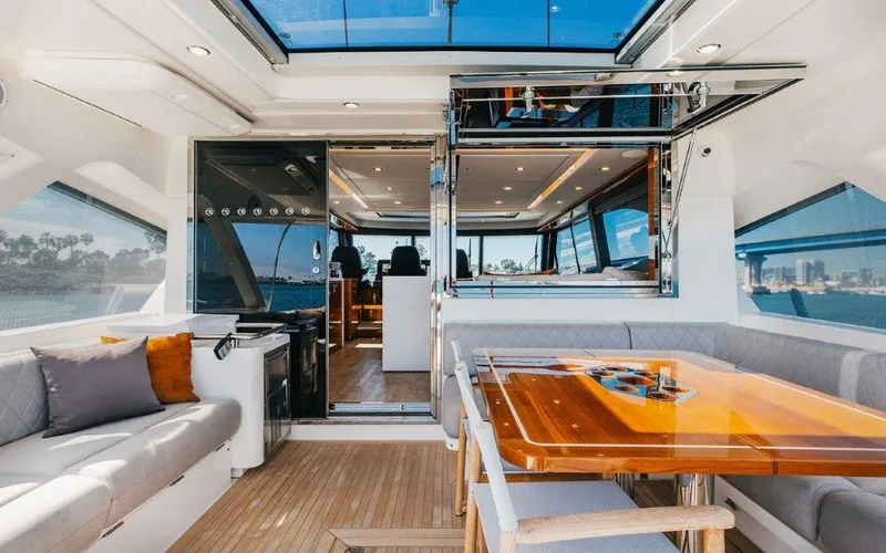 Slide: The Image of Luxurious interior of 2022 Riviera 645 SUV yacht with elegant seating and dining area. - 7
