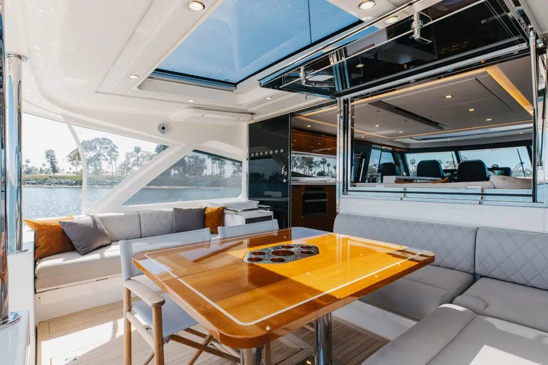 Slide: The Image of Luxurious interior of 2022 Riviera 645 SUV yacht with elegant seating and dining area. - 8
