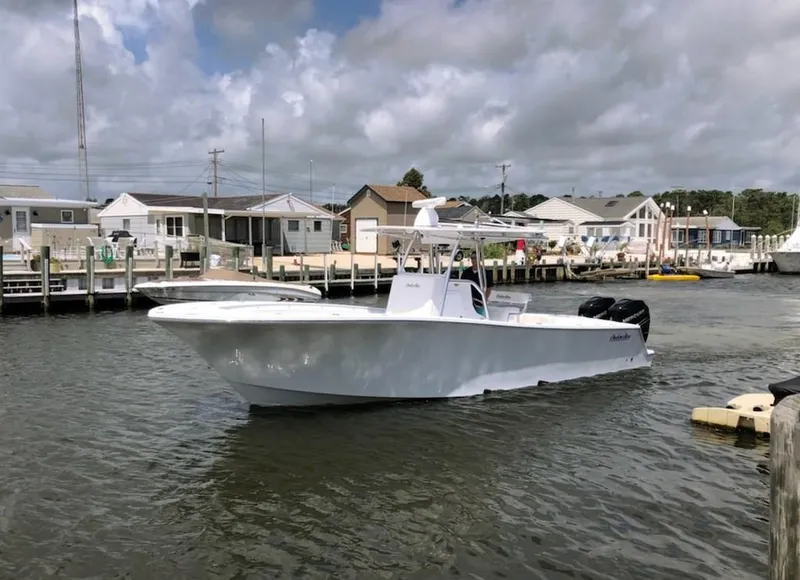 Slide: The Image of 2019 Onslow Bay 33 Tournament boat docked in a marina under cloudy skies. - 1