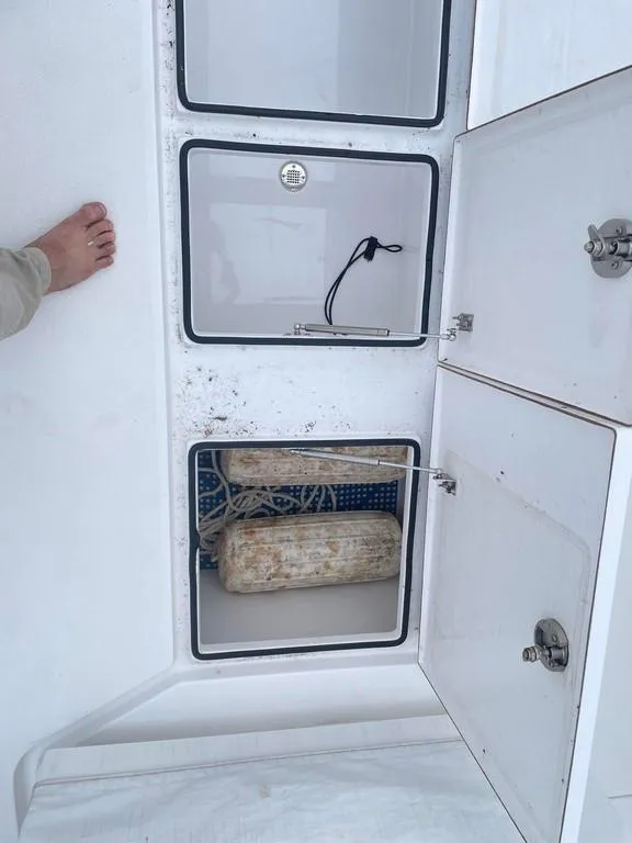 Slide: The Image of 2019 Onslow Bay 33 Tournament boat storage compartments with visible foot. - 12