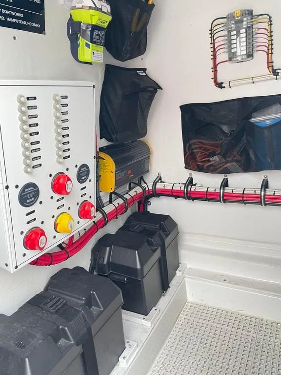 Slide: The Image of Electrical system inside a 2019 Onslow Bay 33 Tournament boat, featuring organized wiring and battery storage. - 16