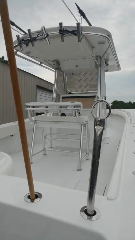 Slide: The Image of 2019 Onslow Bay 33 Tournament boat with T-top and rod holders, docked outdoors. - 19