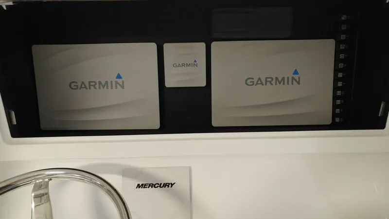Slide: The Image of Garmin navigation screens on a 2019 Onslow Bay 33 Tournament boat dashboard. - 24