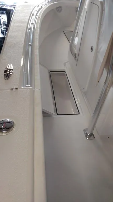 Slide: The Image of 2019 Onslow Bay 33 Tournament boat interior with sleek white design and storage compartment. - 27