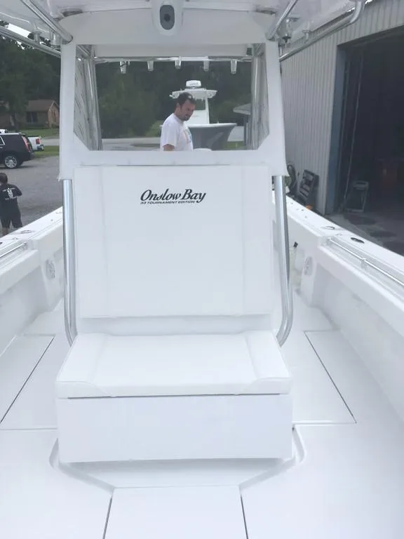 Slide: The Image of 2019 Onslow Bay 33 Tournament boat interior with seating and console. - 29