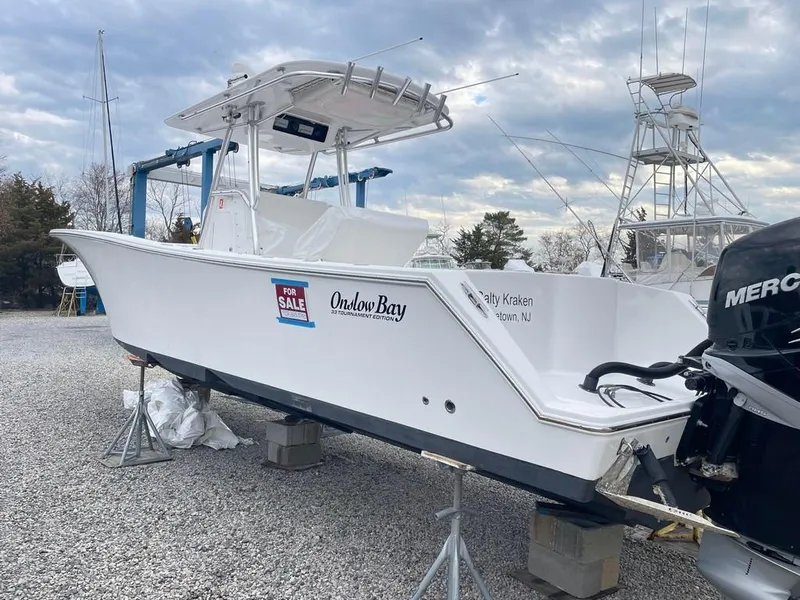 Slide: The Image of 2019 Onslow Bay 33 Tournament boat for sale, displayed on gravel lot. - 3