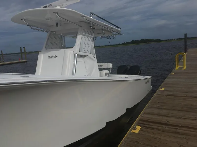 Slide: The Image of 2019 Onslow Bay 33 Tournament boat docked by a wooden pier under cloudy skies. - 30