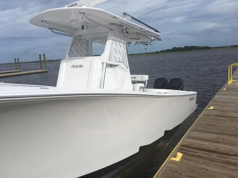 Slide: The Image of 2019 Onslow Bay 33 Tournament boat docked by the water on a cloudy day. - 31