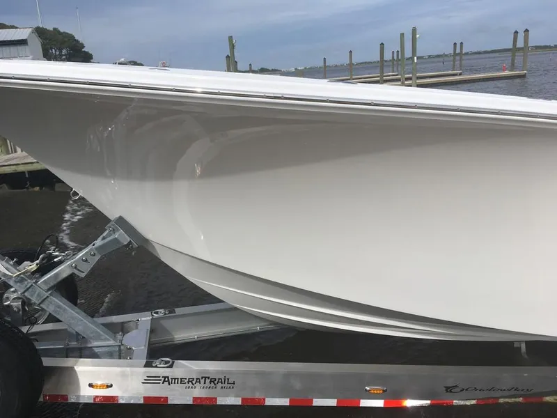 Slide: The Image of 2019 Onslow Bay 33 Tournament boat on trailer by the water. - 32