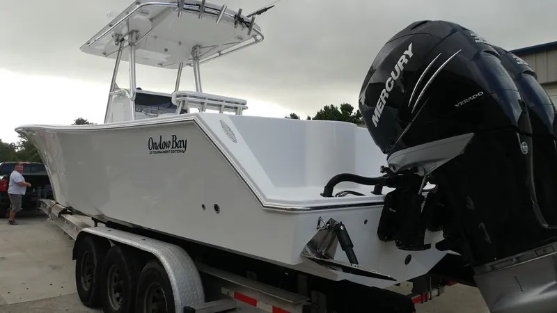 Slide: The Image of 2019 Onslow Bay 33 Tournament boat on trailer with Mercury outboard engine. - 38