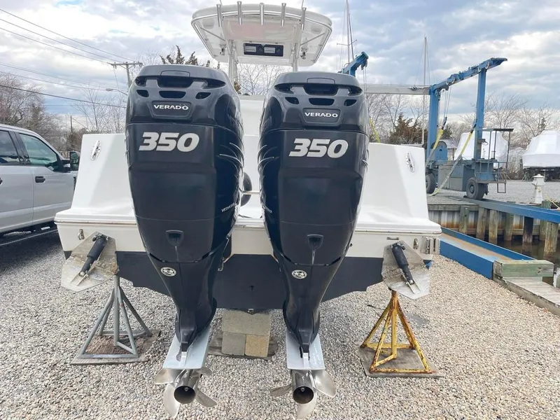 Slide: The Image of 2019 Onslow Bay 33 Tournament boat with twin 350 Verado engines, docked on gravel. - 4