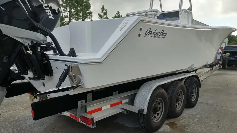 Slide: The Image of 2019 Onslow Bay 33 Tournament boat on a triple-axle trailer, rear view. - 43