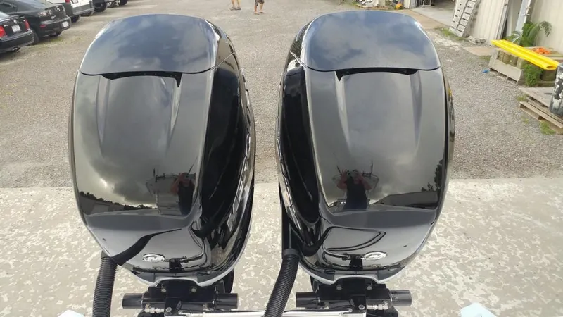 Slide: The Image of Twin black outboard motors on a 2019 Onslow Bay 33 Tournament boat. - 48
