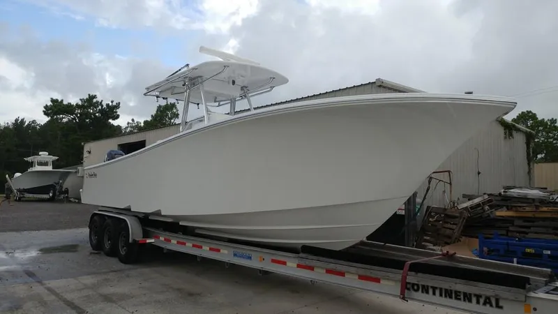 Slide: The Image of 2019 Onslow Bay 33 Tournament boat on trailer, parked outdoors. - 6