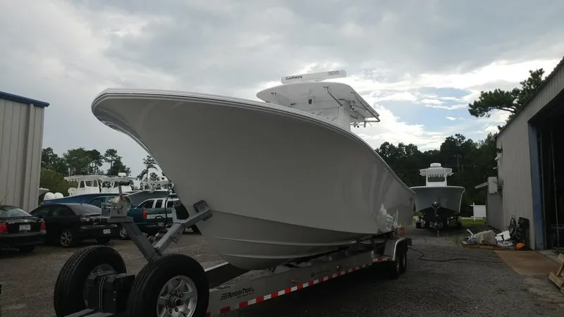 Slide: The Image of 2019 Onslow Bay 33 Tournament boat on trailer in outdoor setting. - 8