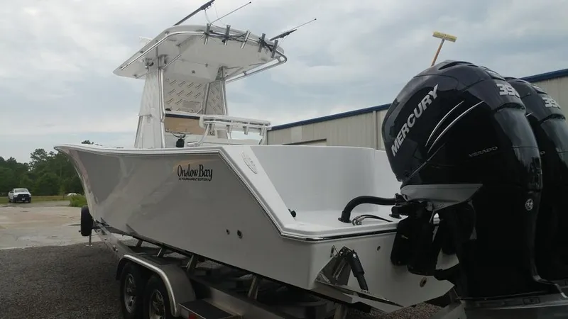 Slide: The Image of 2019 Onslow Bay 33 Tournament boat with dual Mercury engines on a trailer. - 9