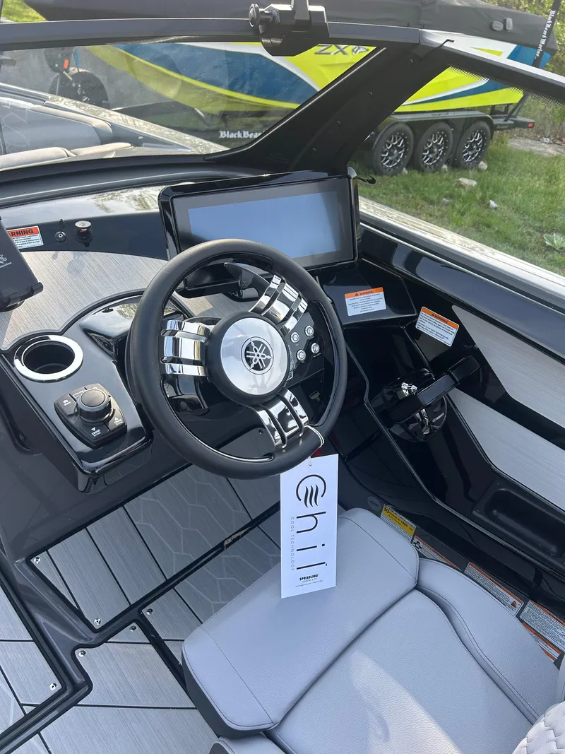 Slide: The Image of 2025 Yamaha Boats 222XD cockpit with modern steering and control panel. - 6
