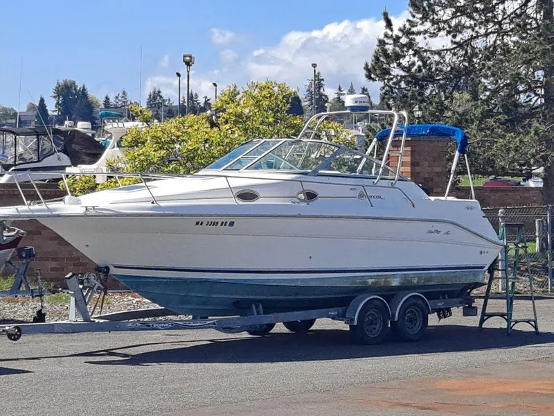 Slide: The Image of 1994 Sea Ray 270 Express boat on trailer, parked outdoors under clear sky. - 5