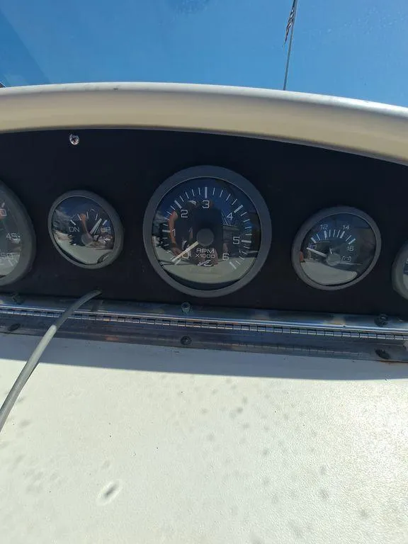 Slide: The Image of Dashboard of a 1994 Sea Ray 270 Express boat with gauges under clear blue sky. - 6