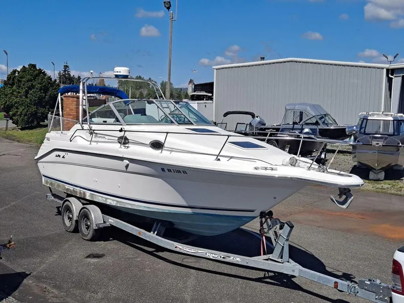 Slide: The Image of 1994 Sea Ray 270 Express boat on trailer, parked outdoors under clear sky. - 8