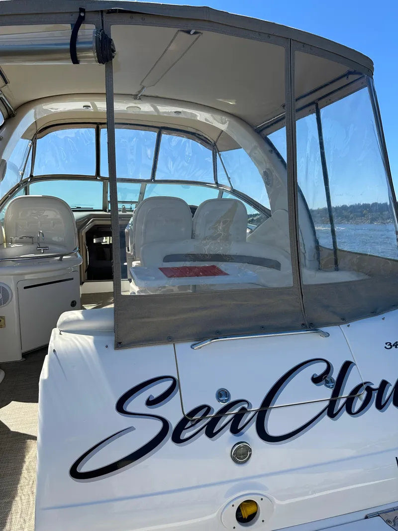 Slide: The Image of 2004 Sea Ray 340 Sundancer boat with "Sea Cloud" name, featuring spacious cockpit and seating. - 19