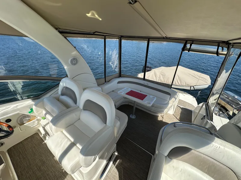 Slide: The Image of 2004 Sea Ray 340 Sundancer interior with white seating and panoramic water views. - 23