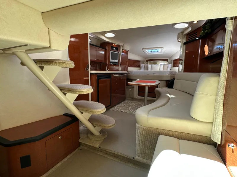 Slide: The Image of 2004 Sea Ray 340 Sundancer interior with kitchen, seating, and stairs. Luxurious yacht cabin design. - 30
