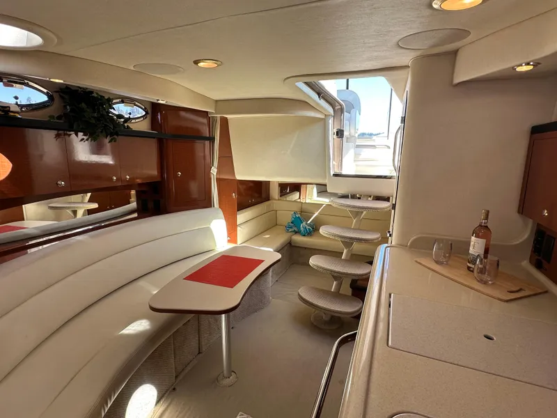Slide: The Image of 2004 Sea Ray 340 Sundancer interior with elegant seating and dining area. - 31