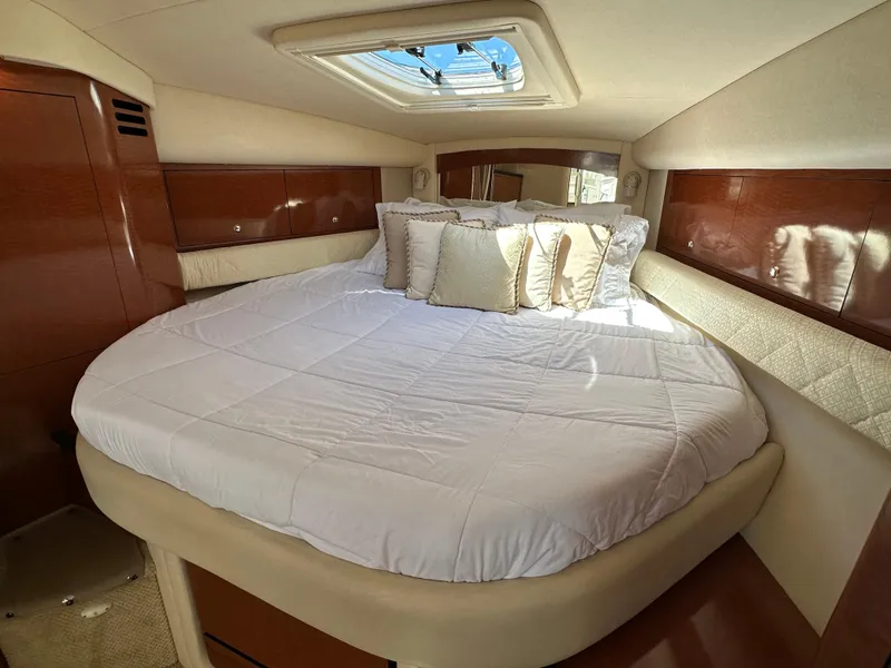 Slide: The Image of Luxurious cabin interior of 2004 Sea Ray 340 Sundancer with plush bedding and skylight. - 35