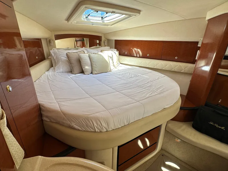Slide: The Image of Luxurious cabin interior of 2004 Sea Ray 340 Sundancer yacht with plush bedding. - 36