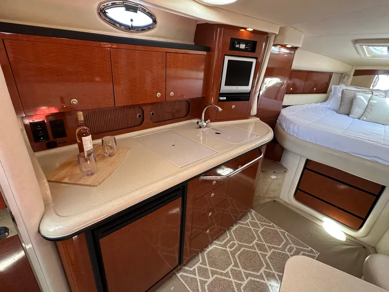 Slide: The Image of Interior of 2004 Sea Ray 340 Sundancer yacht with kitchenette and bed. - 37