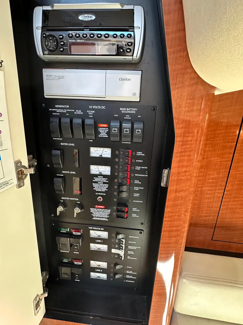 Slide: The Image of Control panel of a 2004 Sea Ray 340 Sundancer boat, featuring various switches and a stereo system. - 41