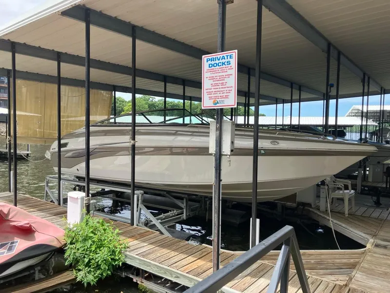 Slide: The Image of 2006 Crownline 270 BR boat docked in a private marina under a covered slip. - 0