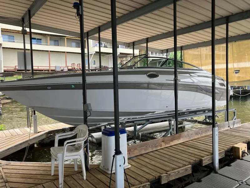 Slide: The Image of 2006 Crownline 270 BR boat docked under covered marina. - 1