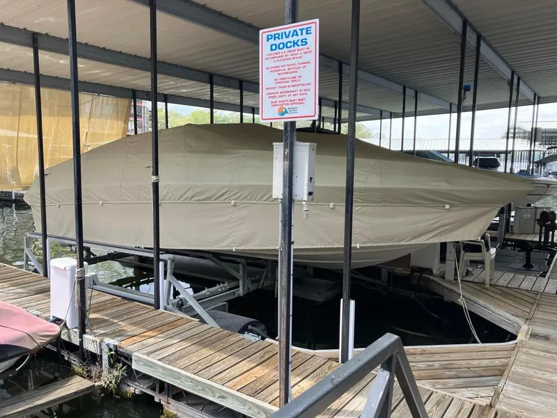 Slide: The Image of Covered 2006 Crownline 270 BR boat docked at private marina. - 10