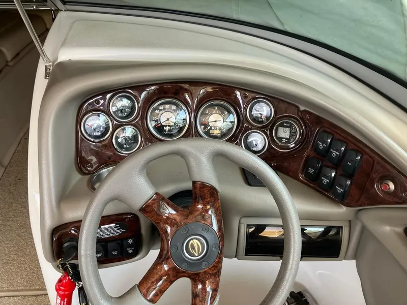 Slide: The Image of Dashboard of a 2006 Crownline 270 BR boat with wood accents and gauges. - 4