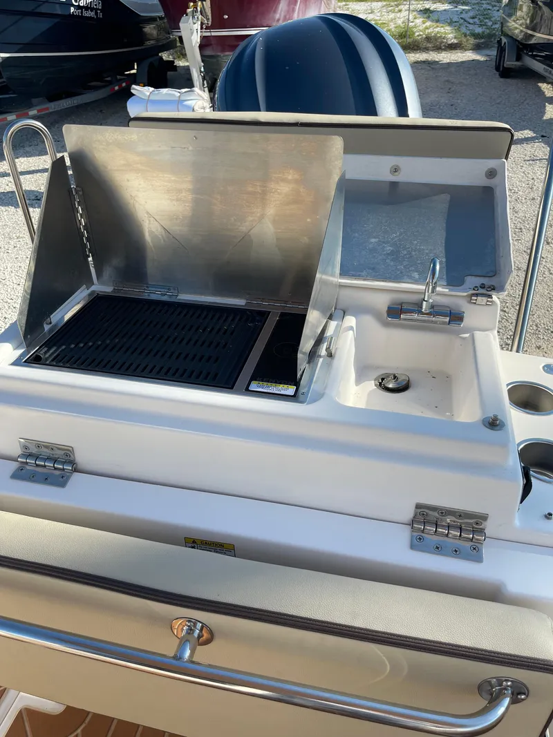 Slide: The Image of Outdoor grill and sink on 2023 Ranger Tugs R-27 boat deck. - 12