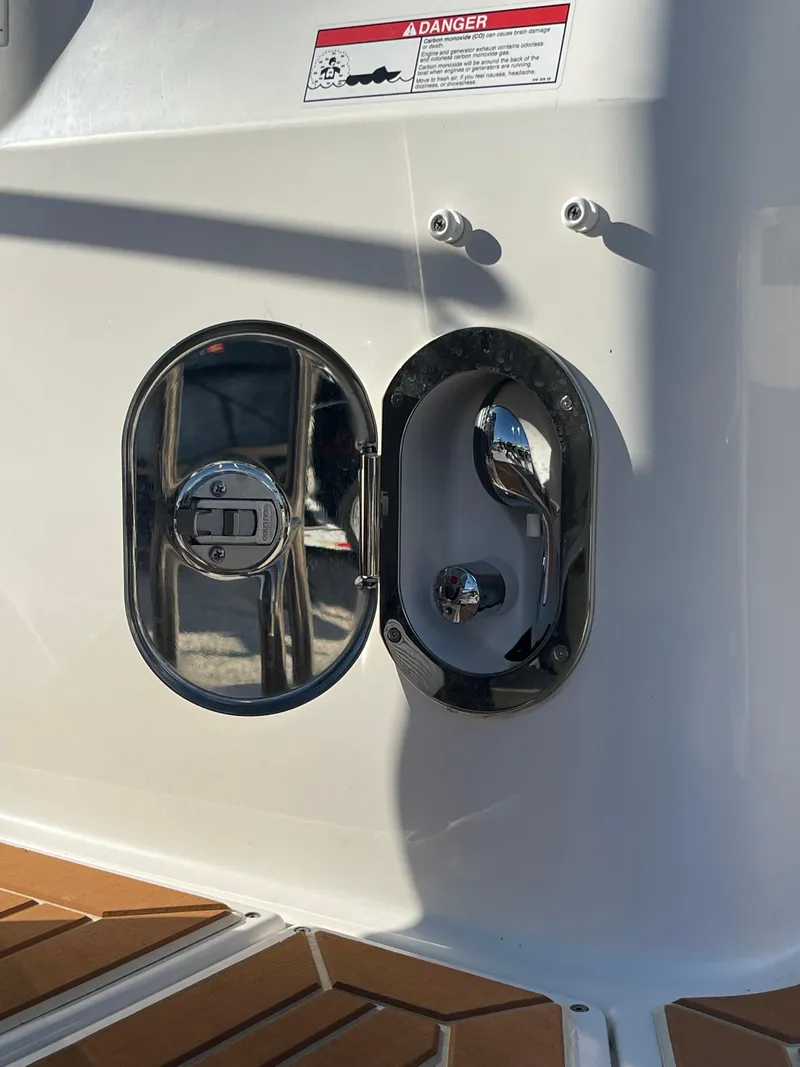 Slide: The Image of 2023 Ranger Tugs R-27 boat fuel cap and handle detail in sunlight. - 13