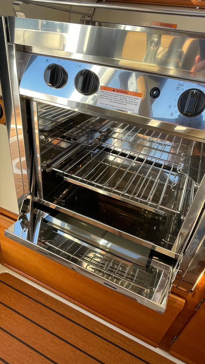 Slide: The Image of Stainless steel oven in 2023 Ranger Tugs R-27 boat interior. - 18