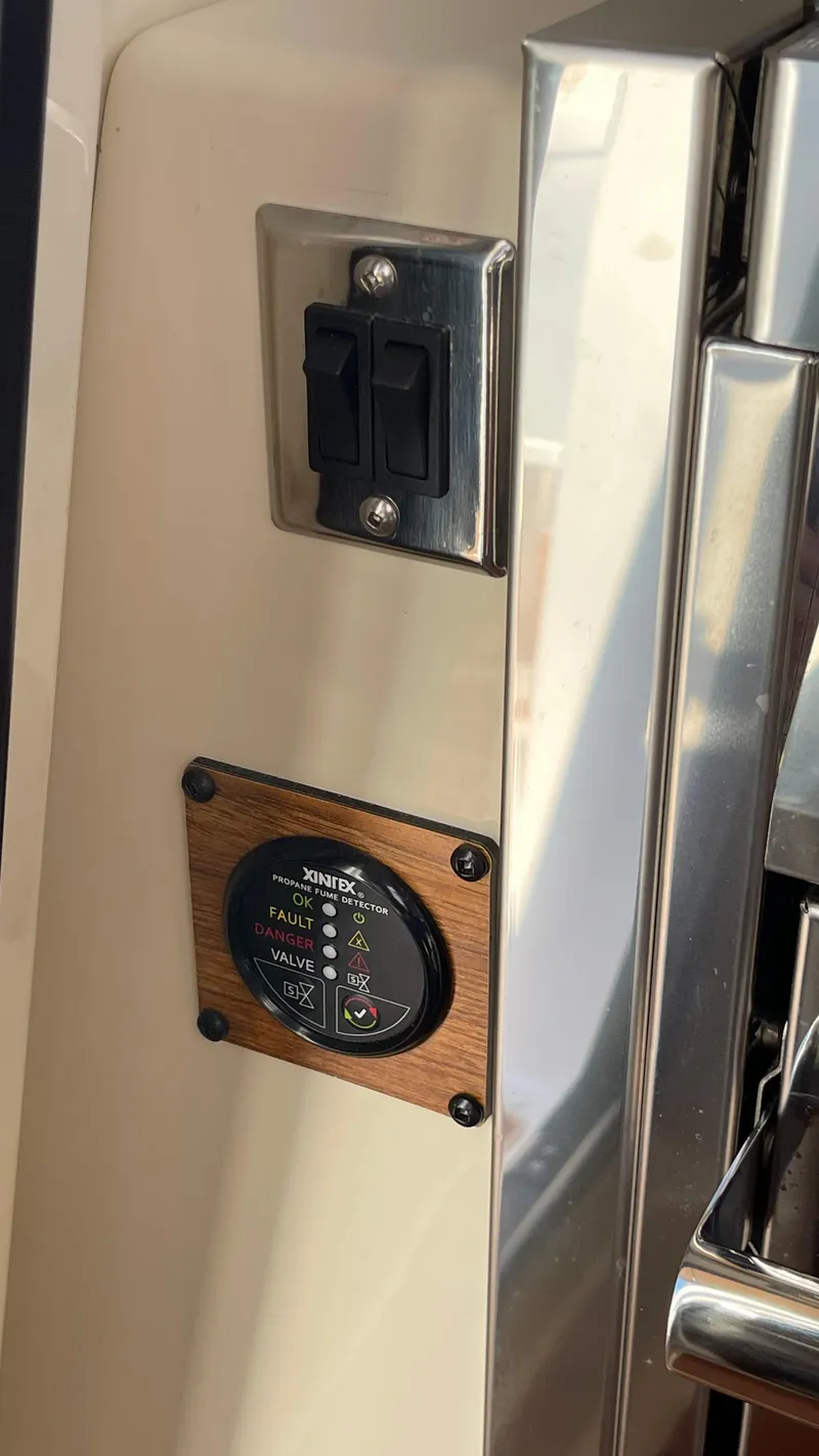 Slide: The Image of 2023 Ranger Tugs R-27 interior control panel with switches and gauge. - 20